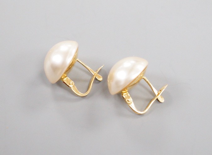 A modern pair of 18k yellow metal and mabe pearl earrings, diameter 13mm, gross weight 5 grams.